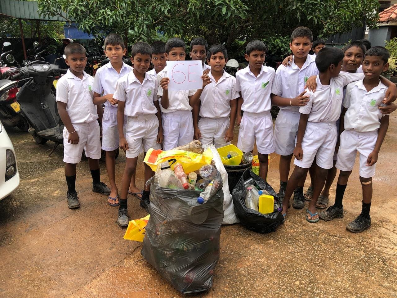 Students of Bandaranayake School with bags of plastic collected through their school recovery programme.