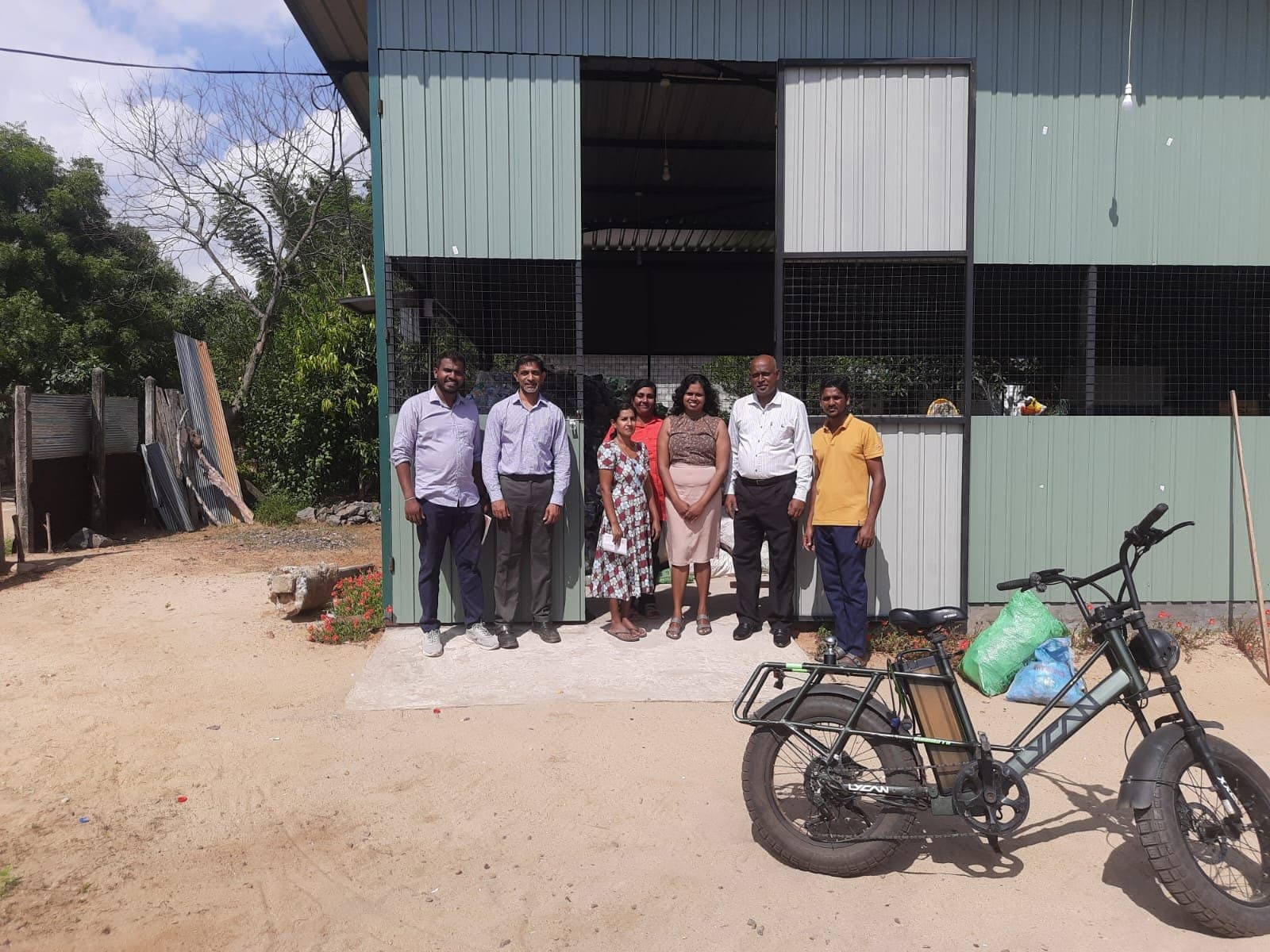 Viji with her team and a collection e-bike outside the Material Recovery Facility she leads.