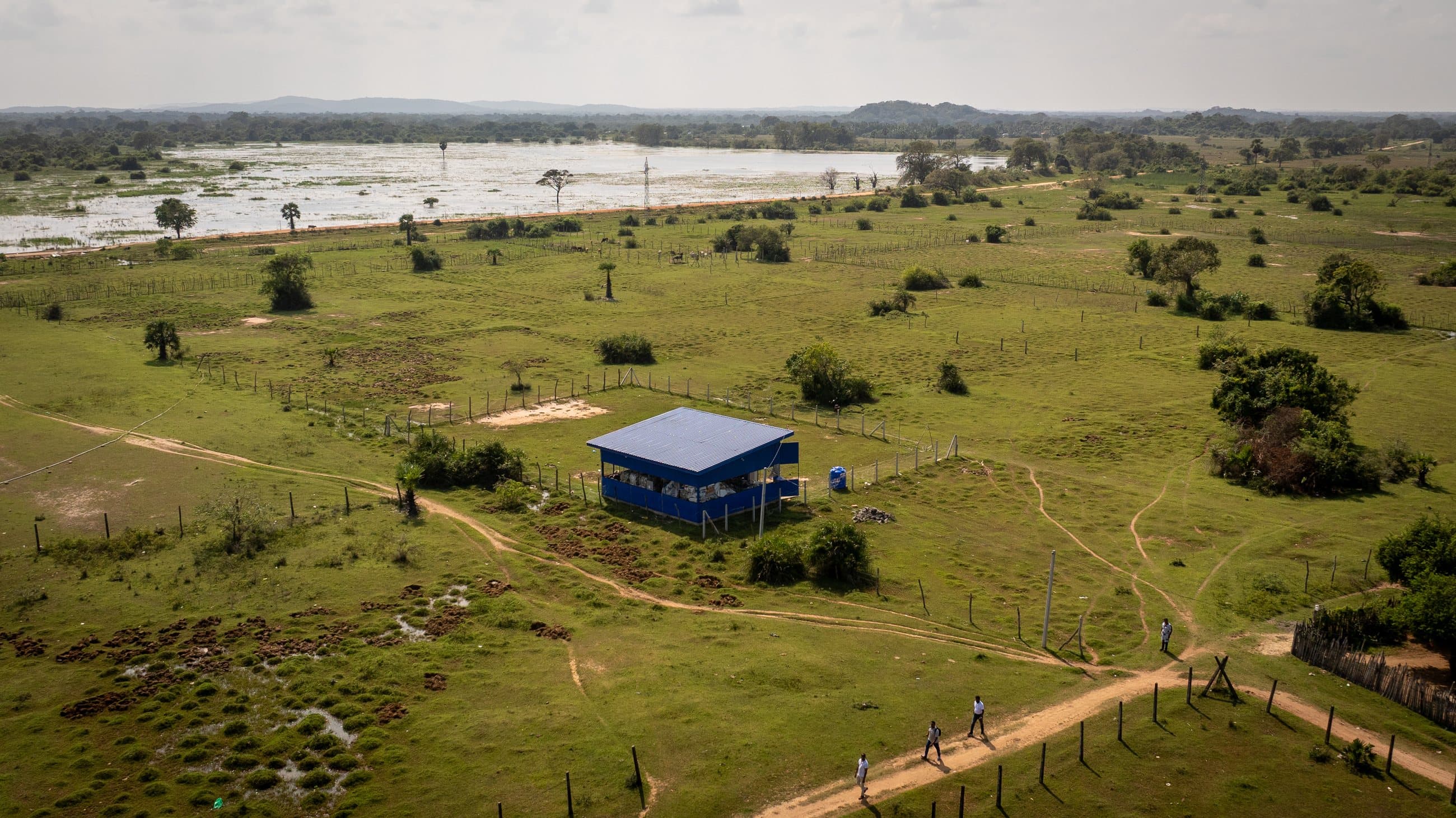 Drone view of an NRC Material Recovery Facility standing in green wetland landscape.