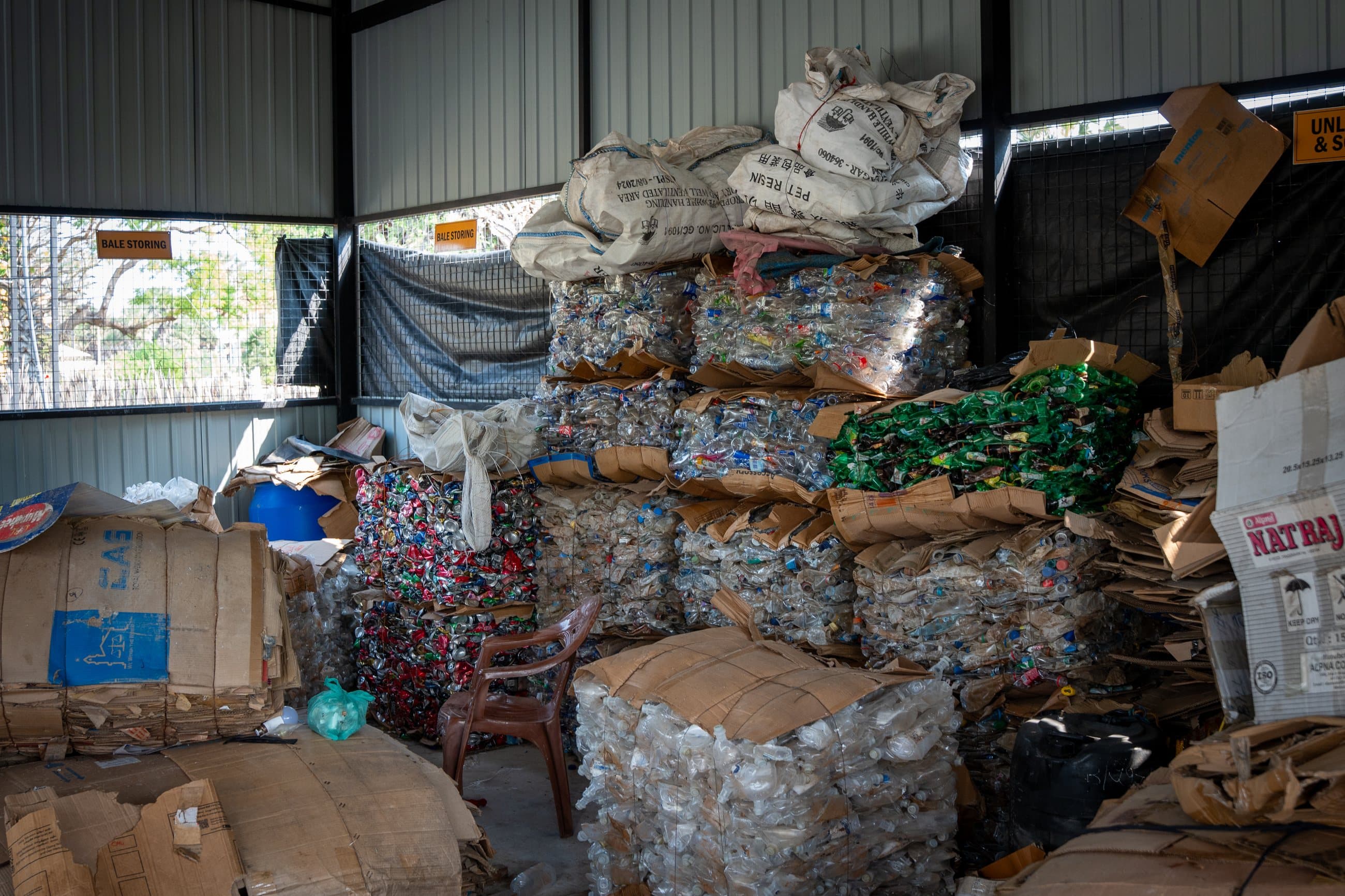 Baled plastics, cans and paper stacked inside an NRC Material Recovery Facility.